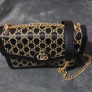 GG monogram black bag with gold color details.
